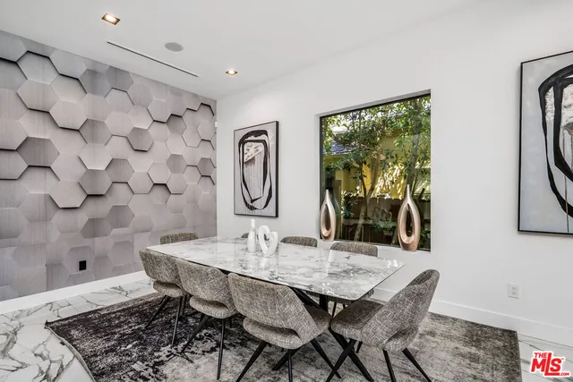 a kitchen with stainless steel appliances a stove a sink and a refrigerator