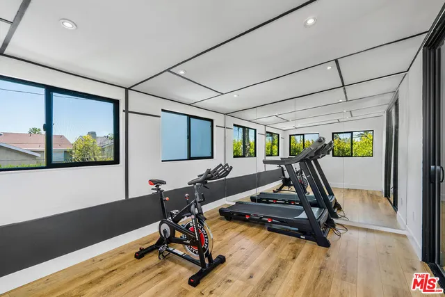 a view of a backyard with plants and outdoor seating