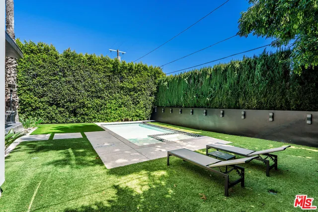 a view of a outdoor dining space with table and chairs