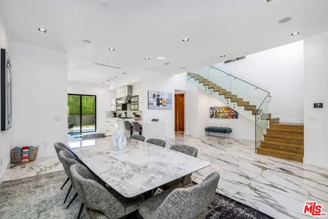 a very nice looking dining room with kitchen island furniture and a wooden floor