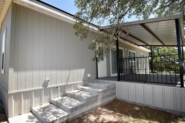 a view of a backyard with a small deck