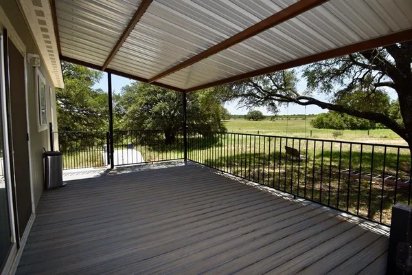 a view of a patio with wooden floor