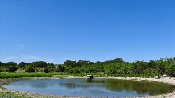 a view of a lake and green valley