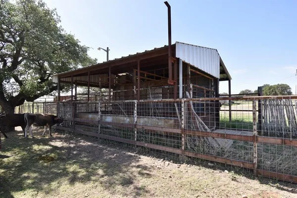 a view of a house with a wooden fence