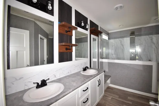a bathroom with a double vanity sink and a mirror