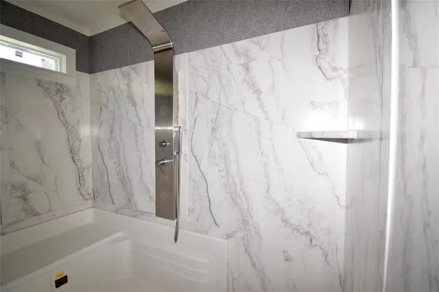 a bathroom with a shower and a tub