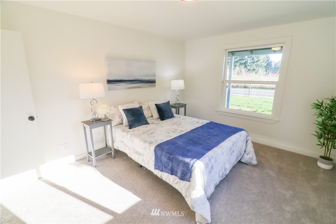 9331 Cullens Road Southeast Yelm, WA 98597 - Photo 14 of 28 a bedroom with a bed and a window