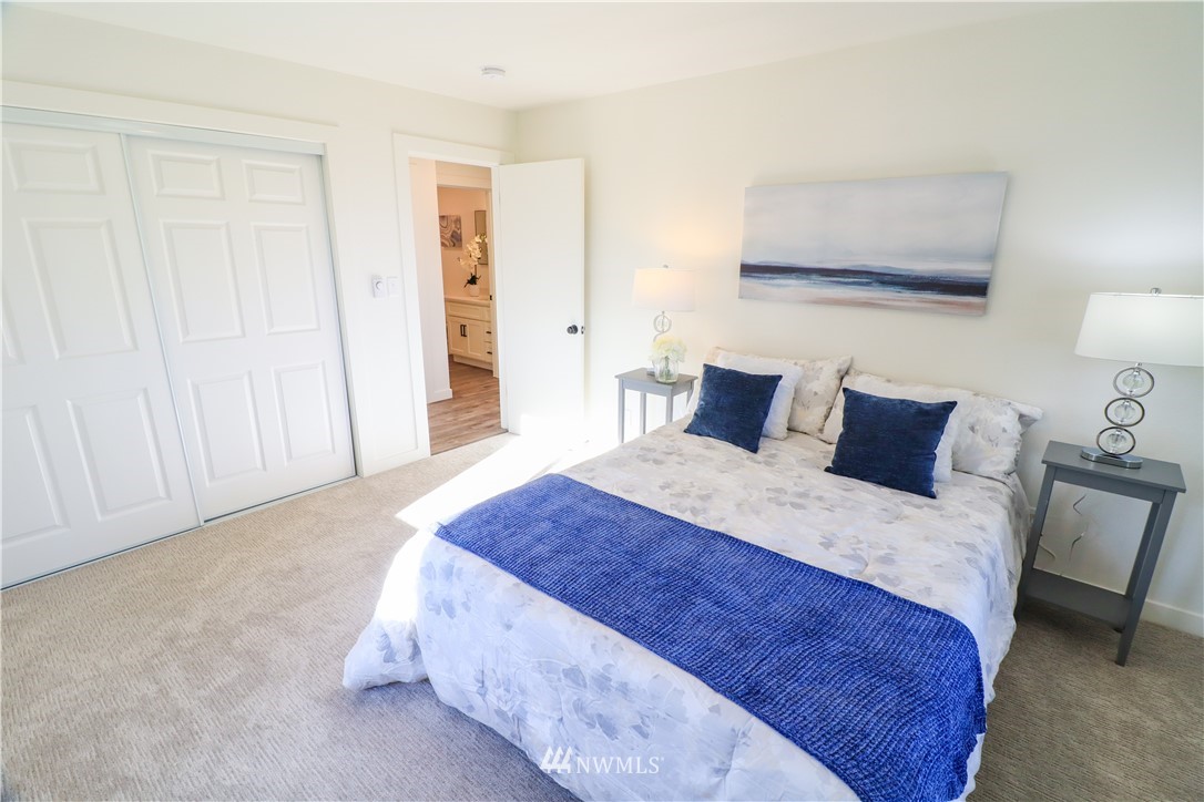 9331 Cullens Road Southeast Yelm, WA 98597 - Photo 15 of 28 a bedroom with a bed and a night stand