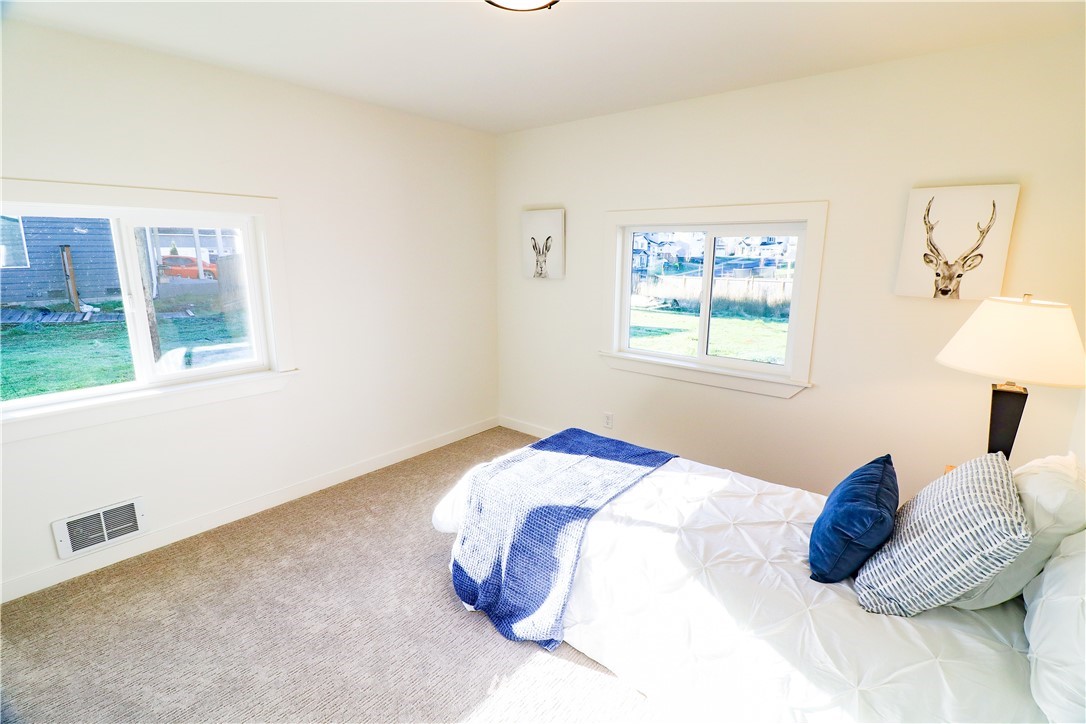 9331 Cullens Road Southeast Yelm, WA 98597 - Photo 16 of 28 a bedroom with a bed and a window