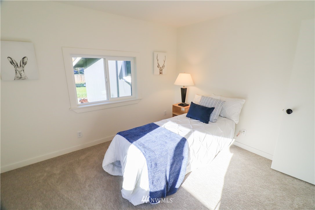 9331 Cullens Road Southeast Yelm, WA 98597 - Photo 17 of 28 a bedroom with a bed and a window