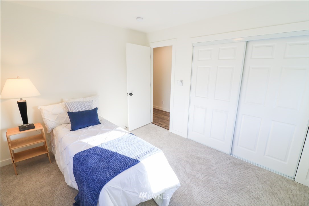 9331 Cullens Road Southeast Yelm, WA 98597 - Photo 18 of 28 a bedroom with a bed and a lamp