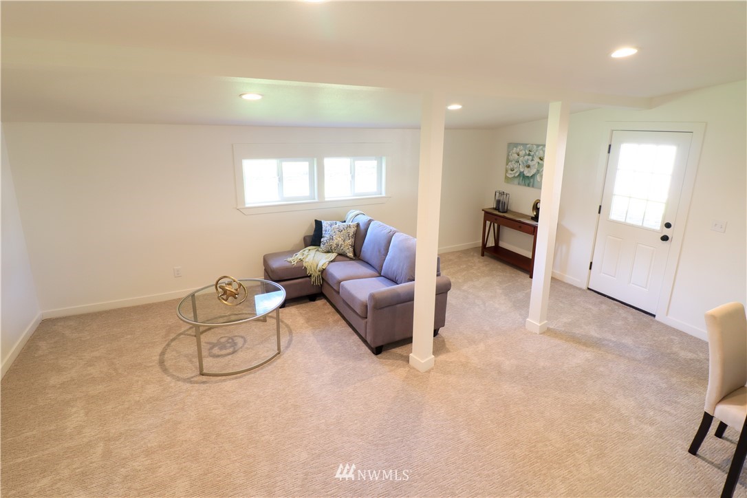 9331 Cullens Road Southeast Yelm, WA 98597 - Photo 23 of 28 a living room with furniture a couch and a window