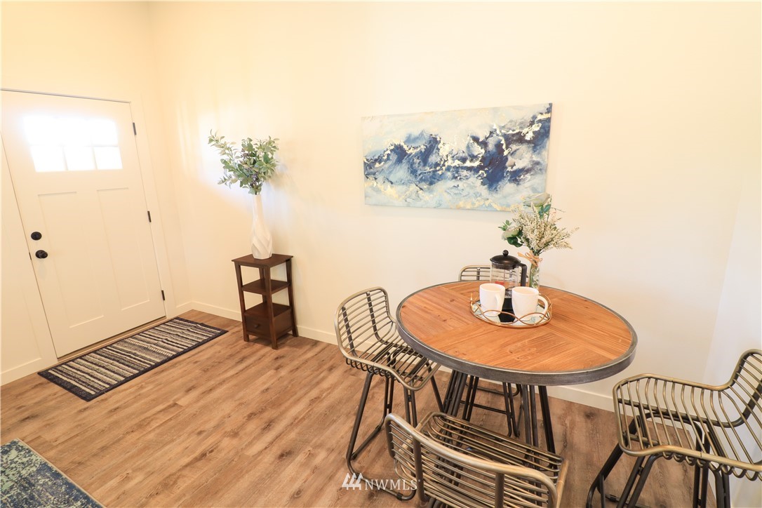 9331 Cullens Road Southeast Yelm, WA 98597 - Photo 7 of 28 a dining room with furniture and wooden floor