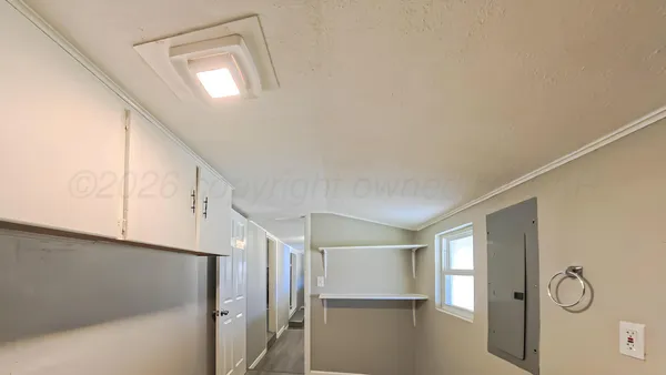 a view of hallway with window and wooden floor