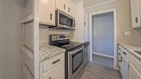 a kitchen with a stove and a microwave
