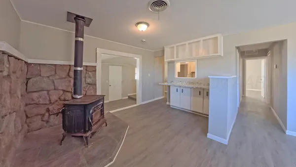 a view of a kitchen with furniture and wooden floor