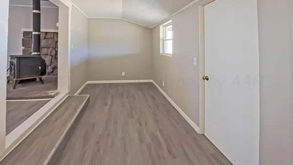 a view of a hallway to a house with wooden floor