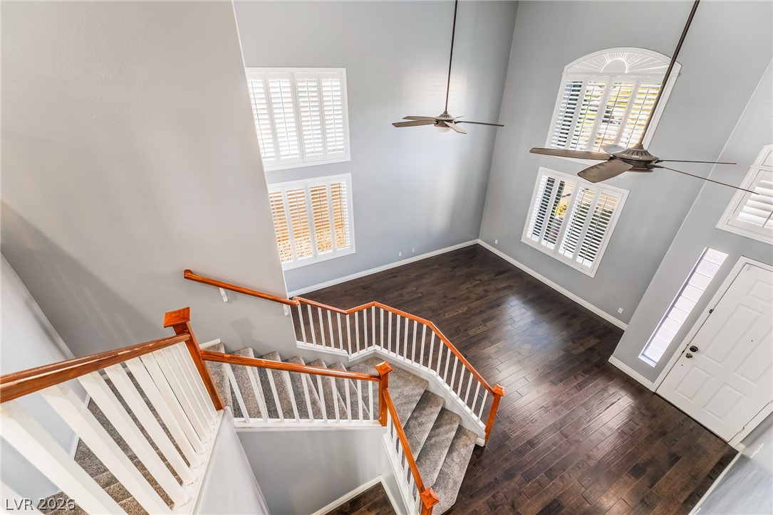 261 Timber Hollow Street Henderson, NV 89012 - Photo 28 of 51 A grand entrance with soaring ceilings and rich hardwood flooring, complemented by a stately staircase.