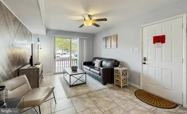 a living room with furniture and a floor to ceiling window