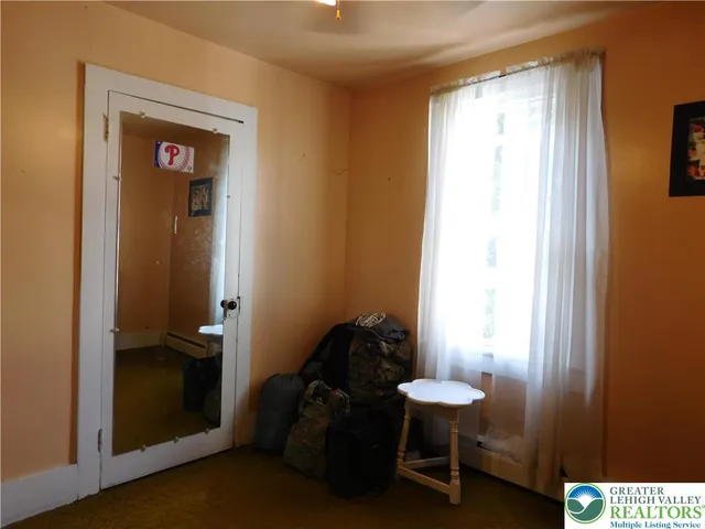 a hallway with chairs and a window