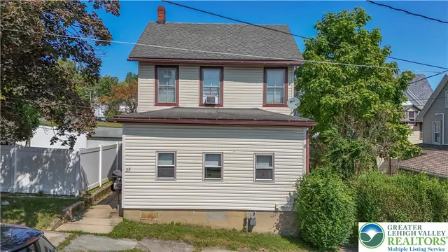 a front view of a house with plants