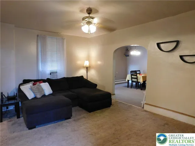 a living room with furniture and a chandelier