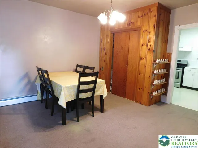 a view of a room with furniture and chandelier