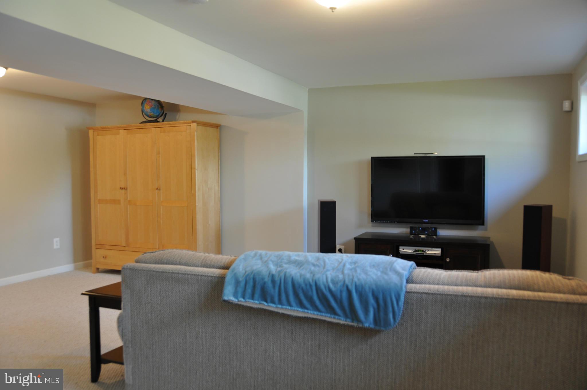 8621 Victoria Road Springfield, VA 22151 - Photo 14 of 27 a bedroom with a bed and a flat screen tv