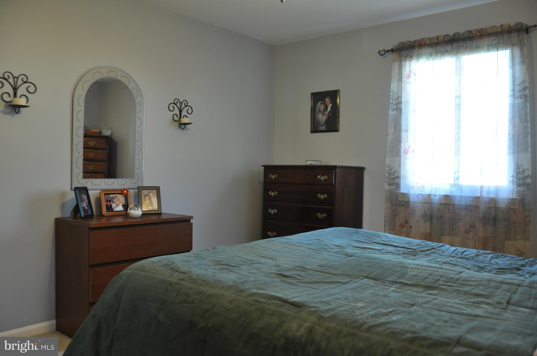 8621 Victoria Road Springfield, VA 22151 - Photo 15 of 27 a bedroom with a bed and a dresser