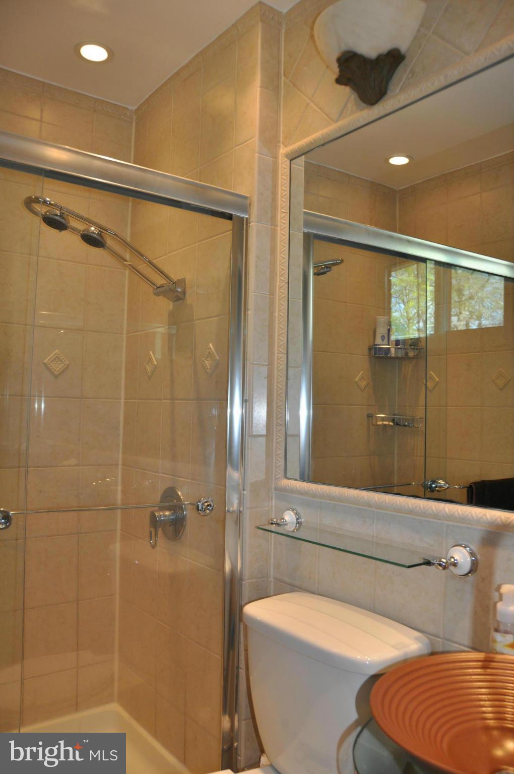 8621 Victoria Road Springfield, VA 22151 - Photo 17 of 27 a bathroom with a toilet and shower