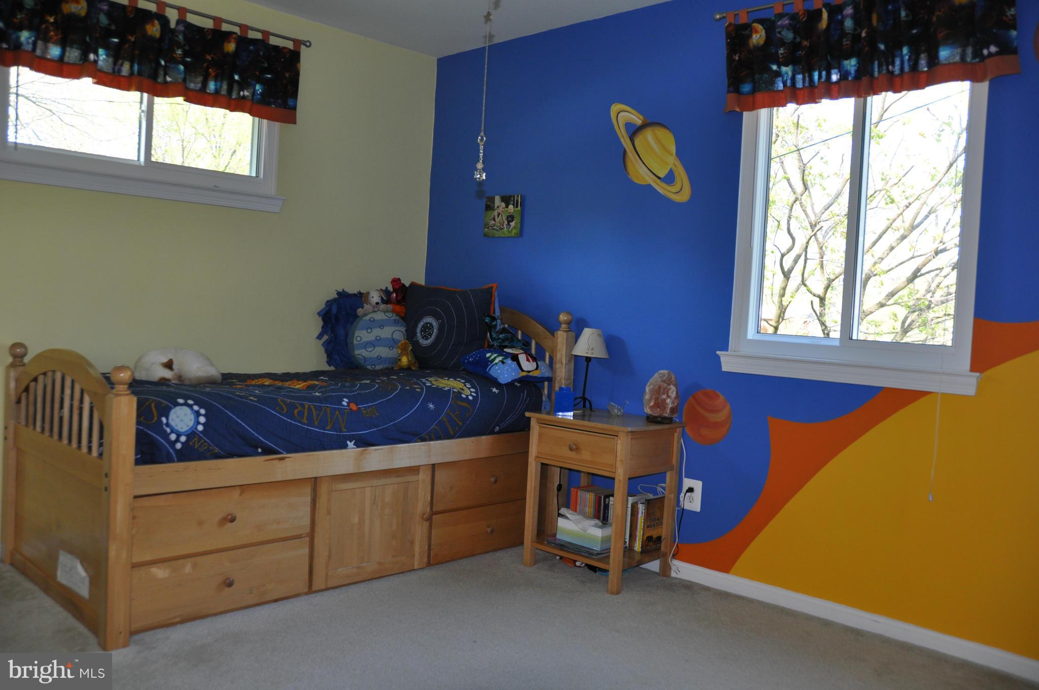 8621 Victoria Road Springfield, VA 22151 - Photo 18 of 27 a bed sitting in a bedroom next to a window