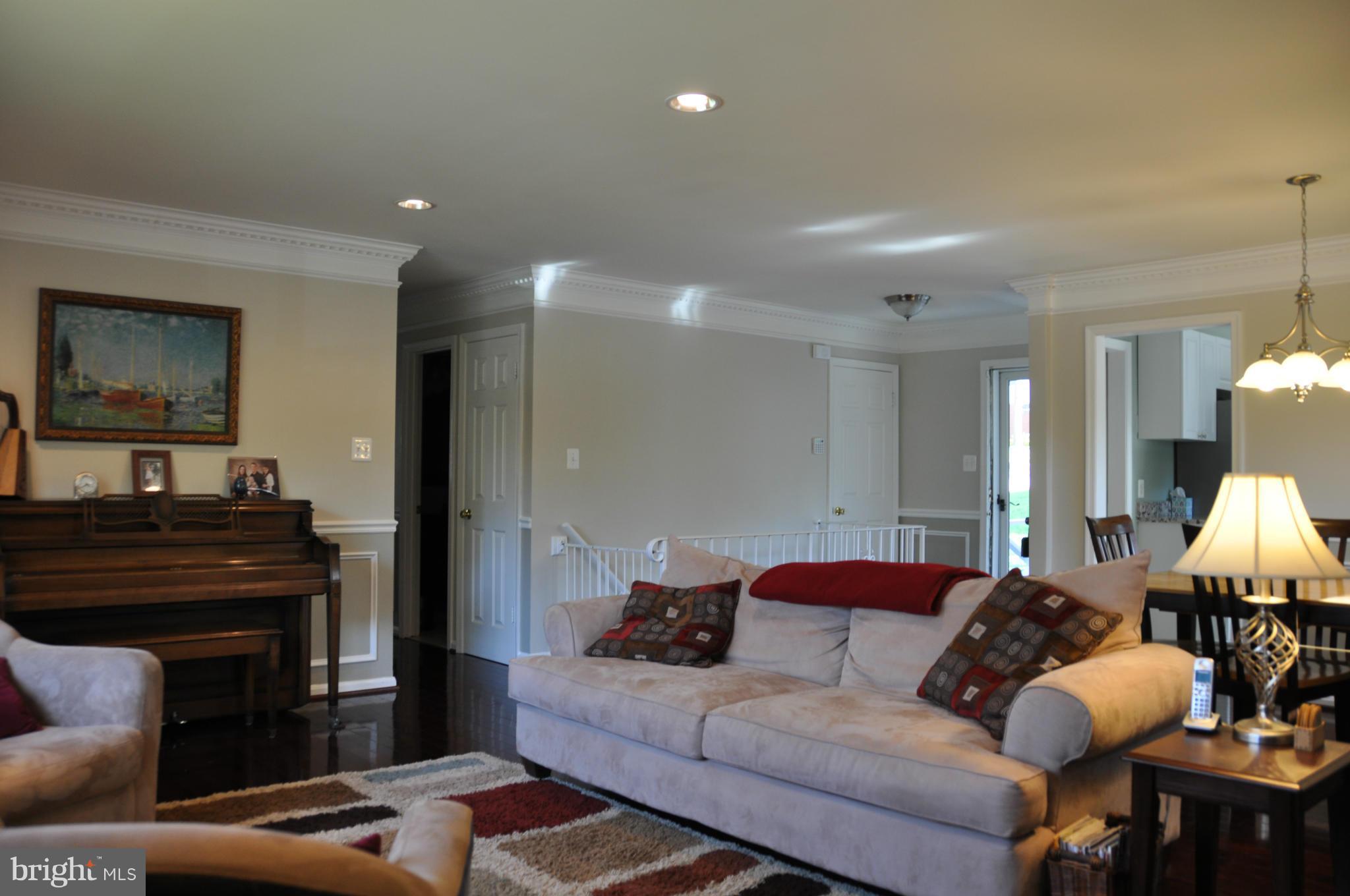 8621 Victoria Road Springfield, VA 22151 - Photo 3 of 27 a living room with furniture and a fireplace