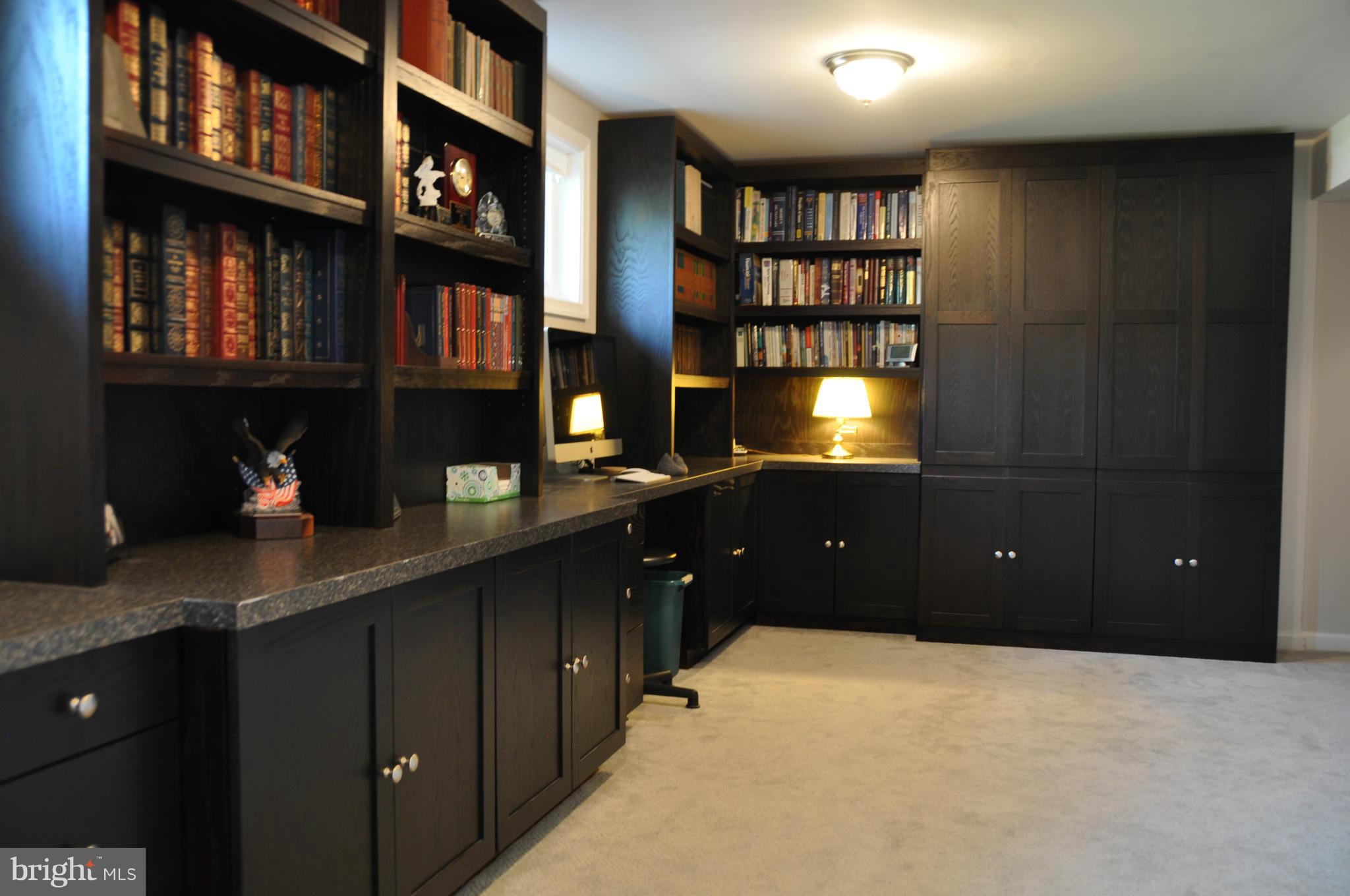 8621 Victoria Road Springfield, VA 22151 - Photo 22 of 27 a room with a cabinet and a bookshelf