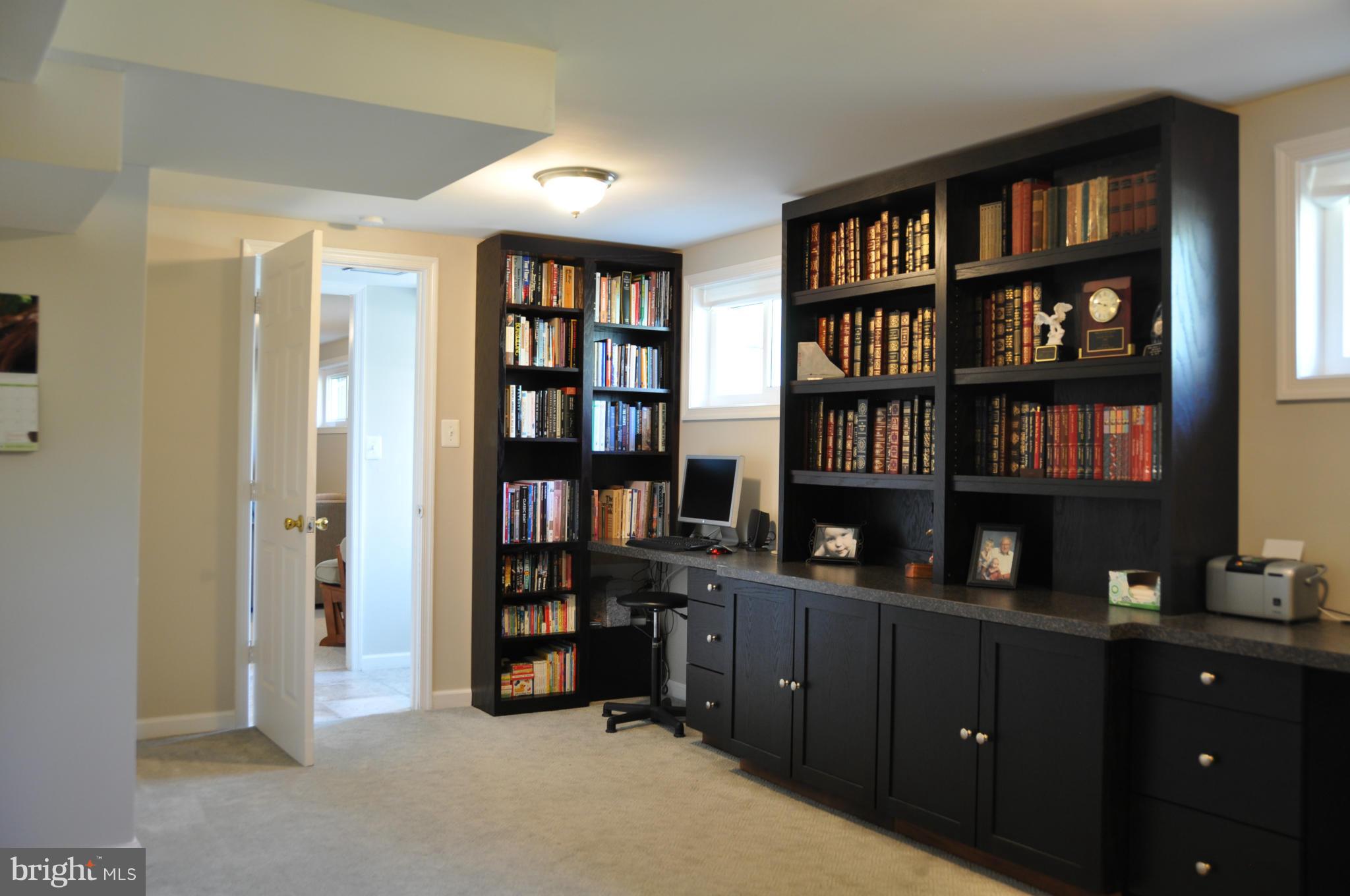8621 Victoria Road Springfield, VA 22151 - Photo 23 of 27 a view of a workspace with bookshelf
