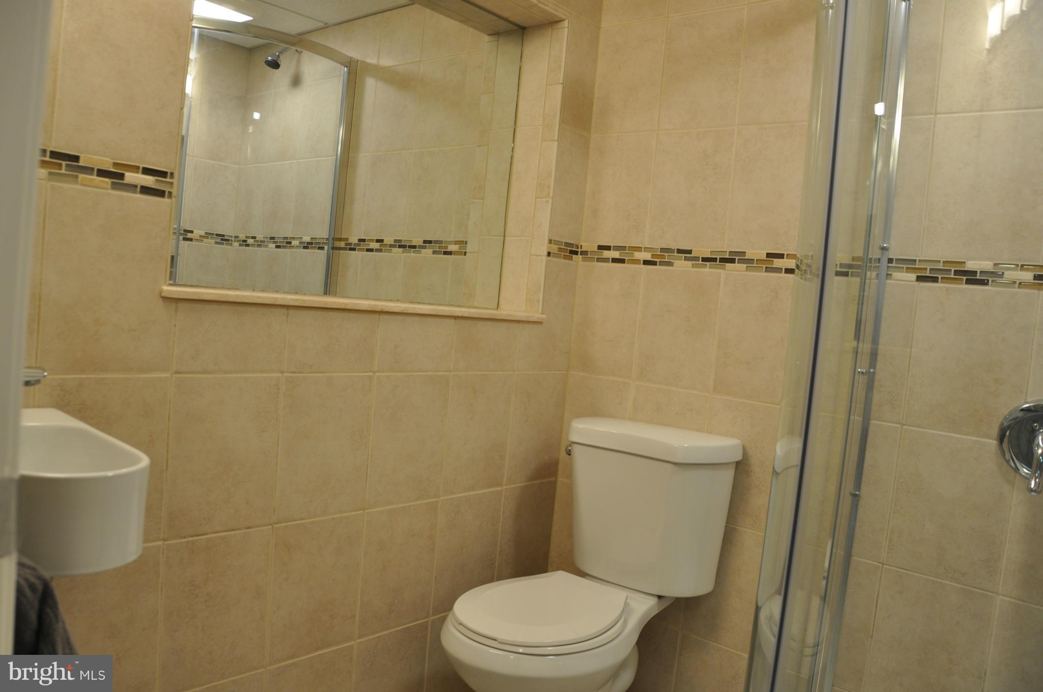 8621 Victoria Road Springfield, VA 22151 - Photo 24 of 27 a bathroom with a toilet and a shower
