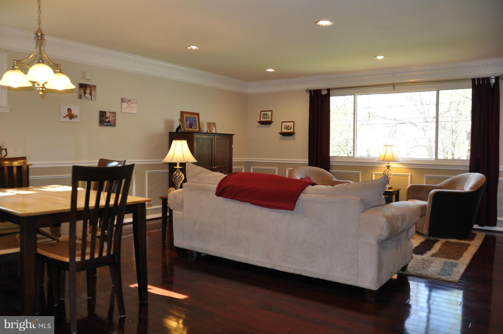 8621 Victoria Road Springfield, VA 22151 - Photo 4 of 27 a living room with furniture a window and a chandelier