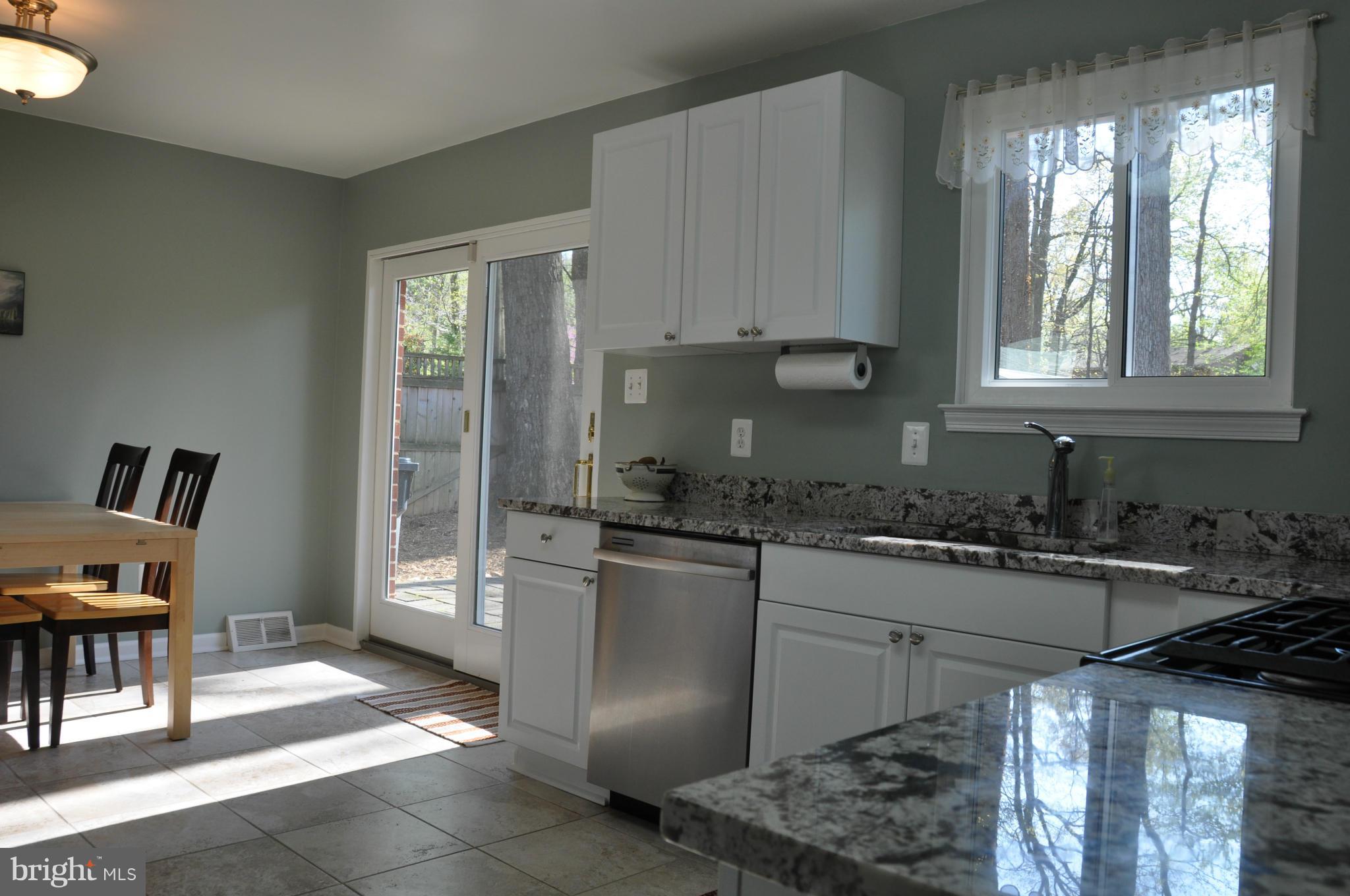 8621 Victoria Road Springfield, VA 22151 - Photo 9 of 27 a kitchen with stainless steel appliances granite countertop a stove a sink and a refrigerator