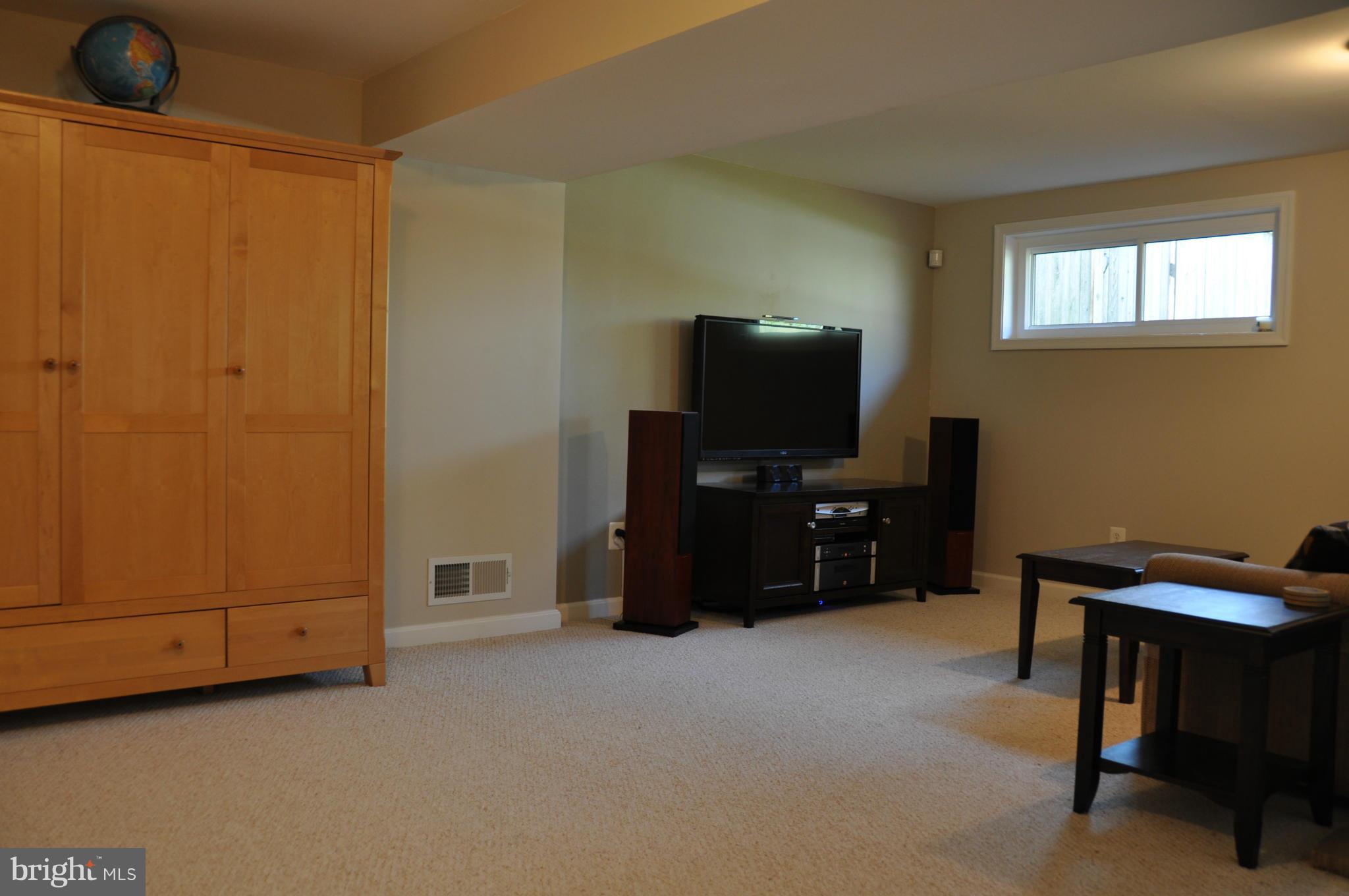 8621 Victoria Road Springfield, VA 22151 - Photo 10 of 27 a living room with furniture and a flat screen tv