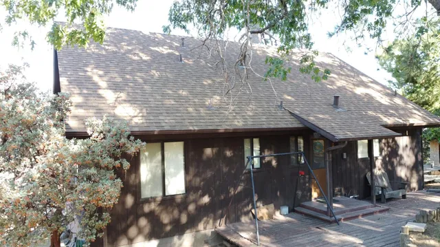 a living room with furniture a flat screen tv and a large window