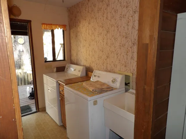 a view of a house with a yard and sitting area