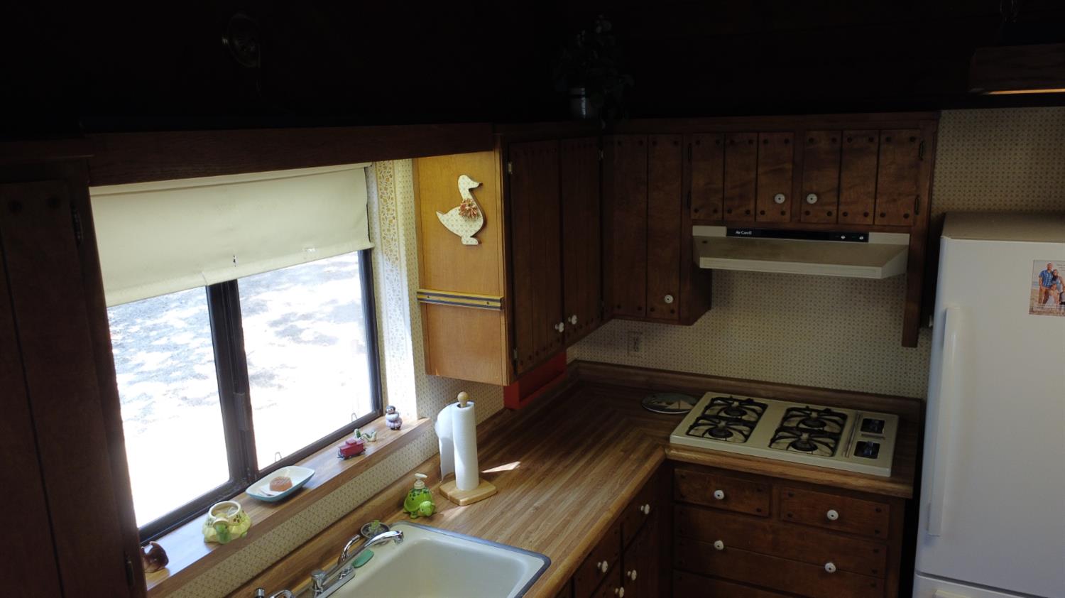 52925 Hogback Miramonte, CA 93603 - Photo 47 of 89 a kitchen with a stove and a refrigerator