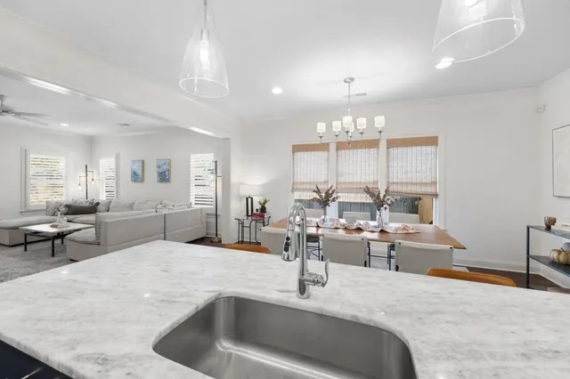 a view of a patio with couches and a table and chairs with wooden fence