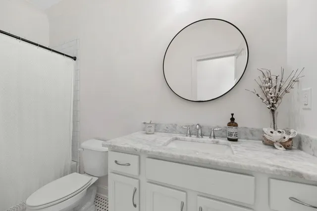 a large white kitchen with a large window