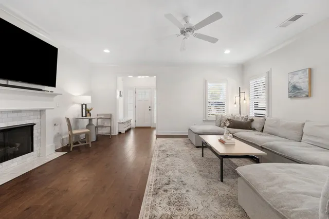 a living room with fireplace furniture and a flat screen tv