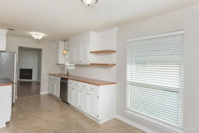 a kitchen with a stove a sink and a refrigerator