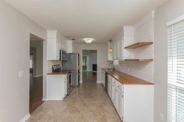 a kitchen with kitchen island a sink stove and refrigerator