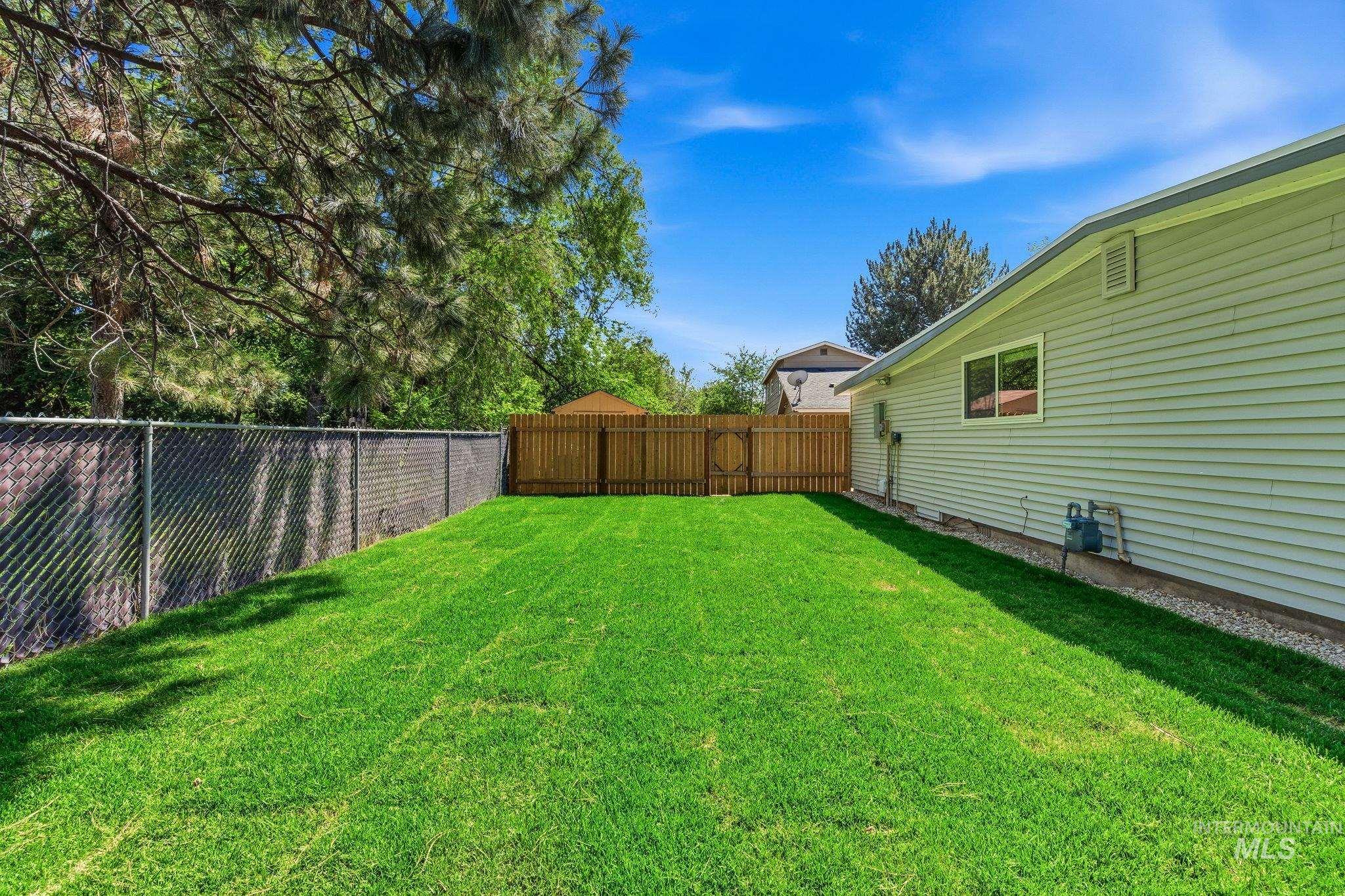 2224 Rachel Circle Boise, ID 83706 - Photo 45 of 50 Spacious backyard featuring a lush green lawn, chain-link fencing, and a privacy fence