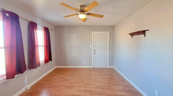 a view of a room with window and a ceiling fan