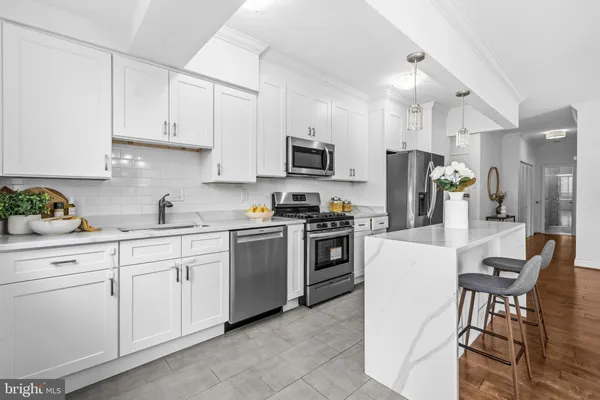 a kitchen with cabinets stainless steel appliances and a counter space