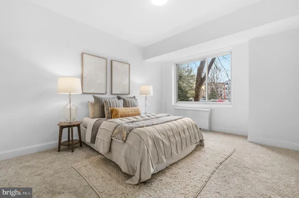 a bed room with a bed and two lamps